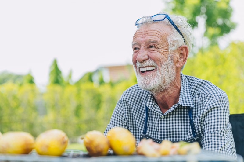 Man smiles outdoors